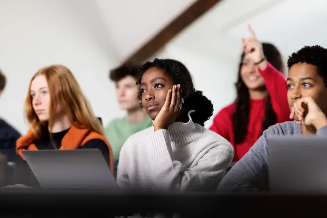 A classroom scene with a diverse group of students focused on a lesson.
