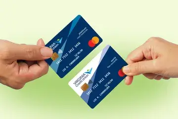 Hands hold two Virginia Credit Union Mastercard credit cards — a cash rewards card and a flex rewards card — in front of a gradient green background.