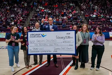 Virginia Credit Union and its Member One division presenting donation of $10,000 to Roanoke-based Carilion Children's Hospital at basketball game