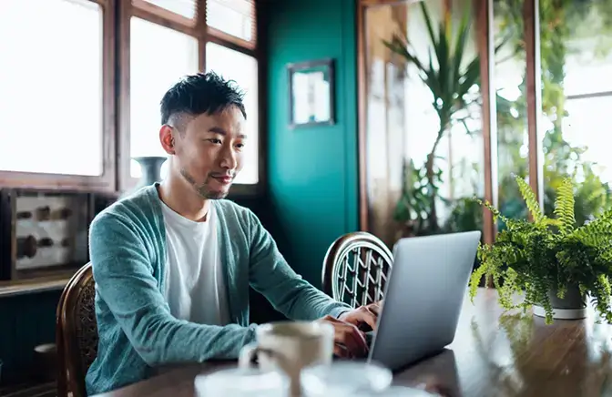 A man at his desk working on a computer 