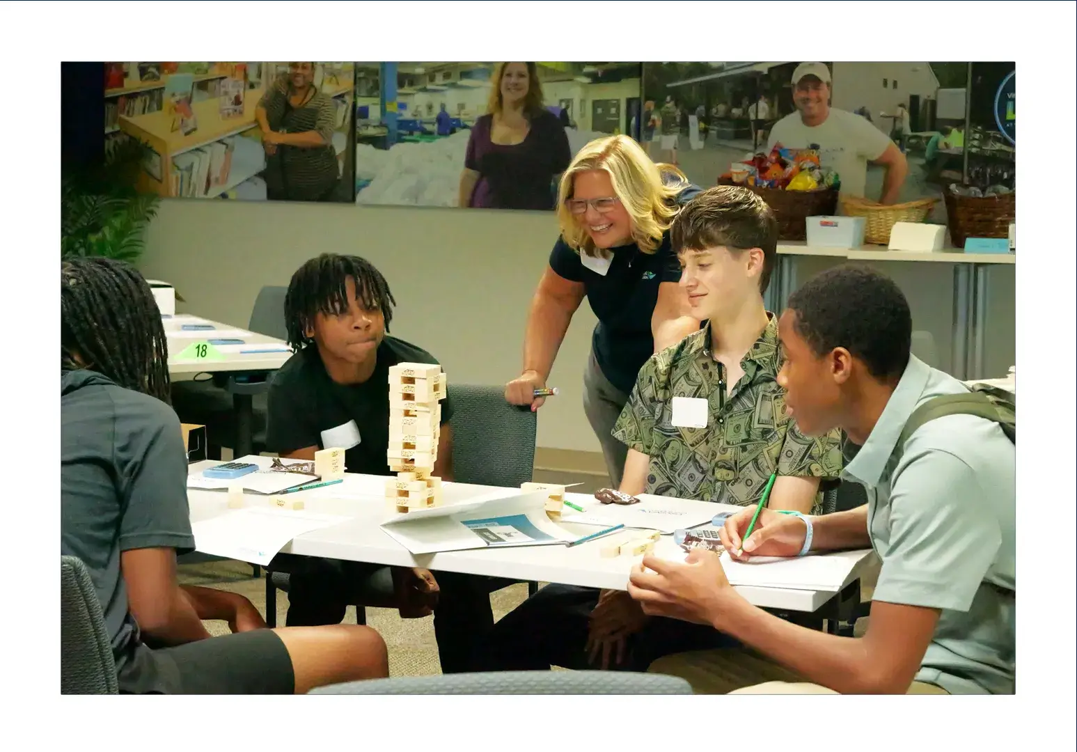 VACU employee smiles while working on a group activity with students