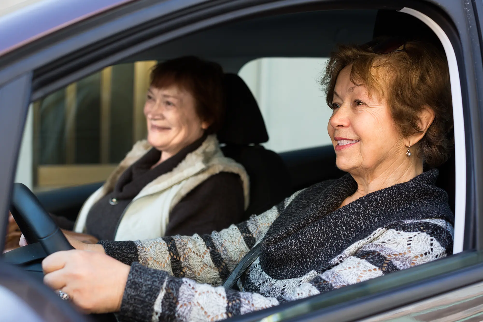 Adobe Stock 196543789 women driving in European city copy