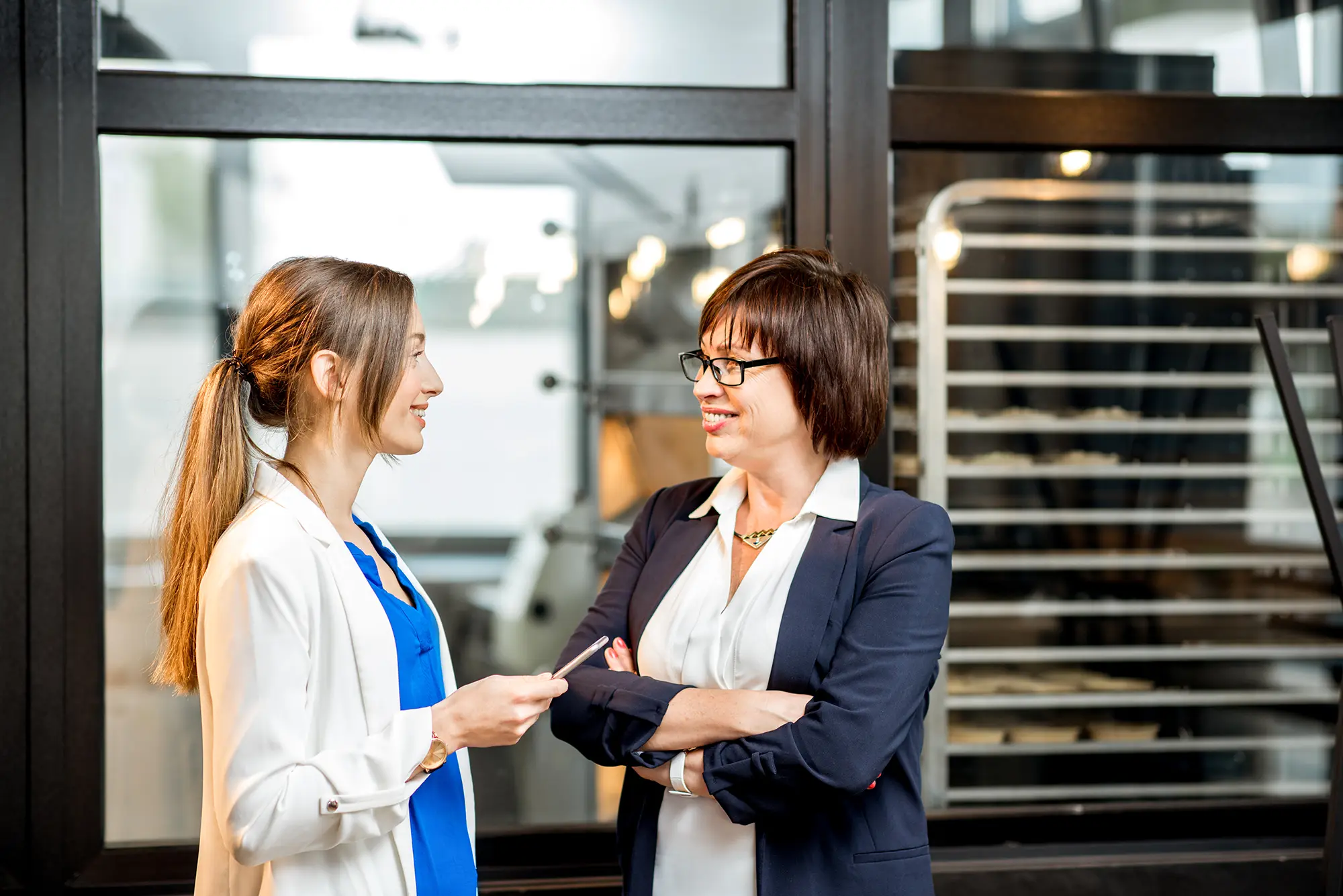 Adobe Stock 203651530 Business women talking in the office of the bakery store copy
