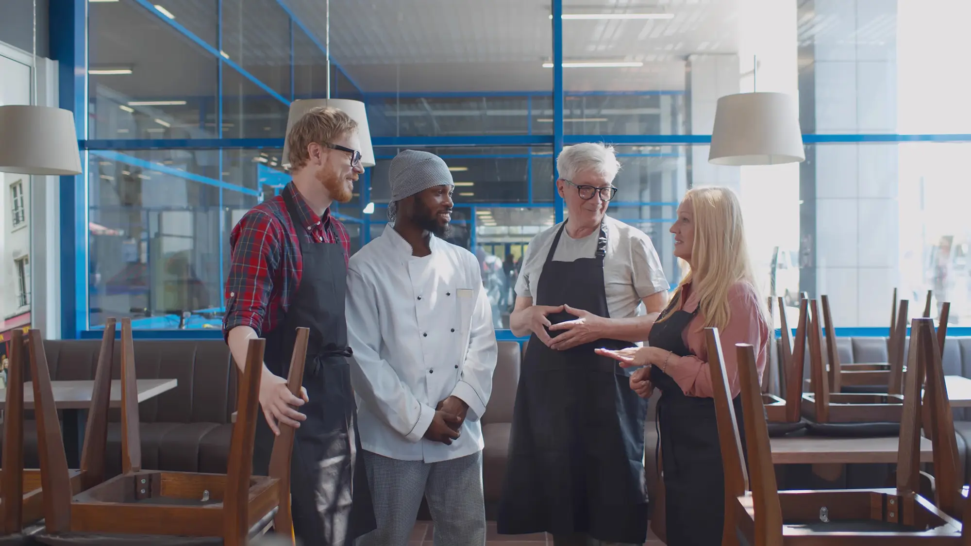 Adobe Stock 366710163 Multiethnic restaurant staff talking before opening copy