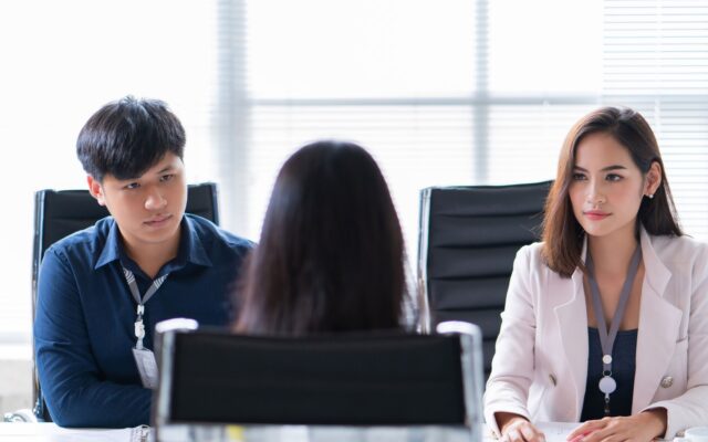 Female job applicant is interviewed in office by two young professionals 978b8d064138018a1dfad71b9882dd21