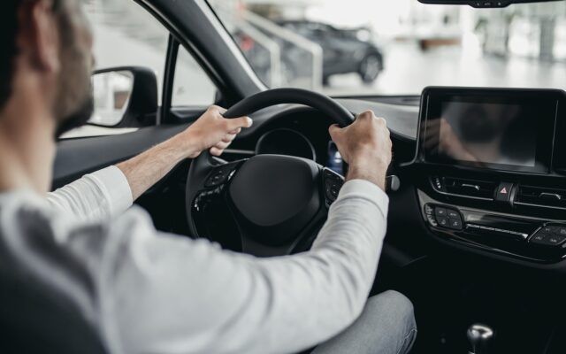 Man tests car in car dealership 978b8d064138018a1dfad71b9882dd21