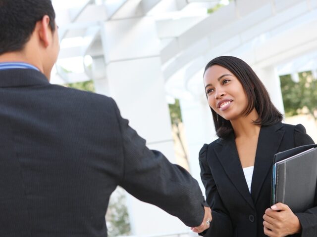 Professional woman shakes bosss hand 978b8d064138018a1dfad71b9882dd21